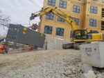 4 Reasons to Invest in a Storage Container for Your Construction Site 40ft Storage Container being carried by excavator