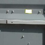 Emergency panic bar exit hardware for office container safety compliance.